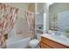 Cozy bathroom with floral shower curtain and bright vanity at 1000 Via Canale Dr, Henderson, NV 89011