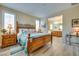 Bright bedroom with wood flooring, shutters, and a view into the connected bathroom at 1000 Via Canale Dr, Henderson, NV 89011