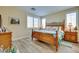 Comfortable bedroom with a wooden frame bed, shutters, and wood-look flooring at 1000 Via Canale Dr, Henderson, NV 89011