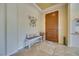 Tastefully decorated foyer with tile flooring and a decorative bench at 1000 Via Canale Dr, Henderson, NV 89011