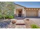 Welcoming front entrance with a paved walkway, stone accents, and desert landscaping at 1000 Via Canale Dr, Henderson, NV 89011
