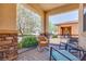 Relaxing covered front porch featuring comfortable seating and a wrought iron railing at 1000 Via Canale Dr, Henderson, NV 89011
