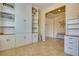 Hallway with tiled floor, built-in shelving, and cozy seating at 1000 Via Canale Dr, Henderson, NV 89011