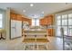 Well-lit kitchen with wood cabinets, granite countertops, and a center island at 1000 Via Canale Dr, Henderson, NV 89011