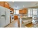 Spacious kitchen with wood cabinetry, granite countertops, and a breakfast bar at 1000 Via Canale Dr, Henderson, NV 89011