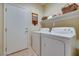 Convenient laundry room with washer, dryer, and storage shelf at 1000 Via Canale Dr, Henderson, NV 89011