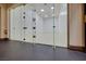 Bright racquetball court featuring a glass wall and well-maintained flooring at 1000 Via Canale Dr, Henderson, NV 89011