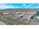 Scenic aerial shot of a commercial center, mountains, and palm tree lined streets, with ample parking space at 10037 Summer Oak Ln # 102, Las Vegas, NV 89134