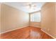 Bedroom with tan colored walls, hardwood floors, plantation shutters and a ceiling fan at 10037 Summer Oak Ln # 102, Las Vegas, NV 89134