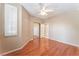 Bedroom with hardwood floors, a ceiling fan, shutters and neutral colored walls at 10037 Summer Oak Ln # 102, Las Vegas, NV 89134
