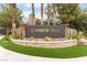 The Summer Trail community sign features a stone wall and lush landscaping with mature palm trees at 10037 Summer Oak Ln # 102, Las Vegas, NV 89134