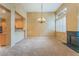 Spacious dining room with high ceilings, chandelier, fireplace, and large windows with plantation shutters at 10037 Summer Oak Ln # 102, Las Vegas, NV 89134