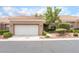 Charming single-story home featuring a well-manicured yard and an attached two-car garage at 10037 Summer Oak Ln # 102, Las Vegas, NV 89134
