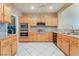 Bright kitchen features stainless steel appliances, gas cooktop, granite counters, and light wood cabinets at 10037 Summer Oak Ln # 102, Las Vegas, NV 89134