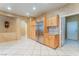 Open concept kitchen featuring stainless steel fridge, custom cabinetry, and tile flooring at 10037 Summer Oak Ln # 102, Las Vegas, NV 89134