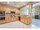 Open kitchen featuring stainless steel appliances, light cabinetry, and seamless flow to the dining area at 10037 Summer Oak Ln # 102, Las Vegas, NV 89134