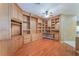 Spacious living room with hardwood floors and a wall of custom built-in cabinets and shelving at 10037 Summer Oak Ln # 102, Las Vegas, NV 89134