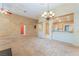 Expansive living room boasts neutral carpet, chandelier, and convenient access to the kitchen area at 10037 Summer Oak Ln # 102, Las Vegas, NV 89134