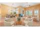 Staged living room featuring a cozy seating area and elegant dining set at 10037 Summer Oak Ln # 102, Las Vegas, NV 89134