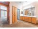 Bright main bathroom with double sinks, cabinets and drawers and a view to the toilet and shower room at 10037 Summer Oak Ln # 102, Las Vegas, NV 89134