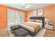 This virtually staged main bedroom features a king bed, neutral decor and natural light from sliding glass doors at 10037 Summer Oak Ln # 102, Las Vegas, NV 89134