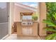 This cozy outdoor kitchen features a stainless steel grill with a built-in prep area and cabinetry at 10037 Summer Oak Ln # 102, Las Vegas, NV 89134