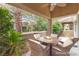 Back patio with a fire pit table, cushioned chairs and a ceiling fan for comfort at 10037 Summer Oak Ln # 102, Las Vegas, NV 89134
