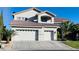 Charming two-story home with a three-car garage, desert landscaping, and a red tile roof at 10234 Renae Nicole Ct, Las Vegas, NV 89183