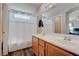 Bathroom with dual sinks and a tub/shower combination and decorative window at 10454 Gunpowder Falls St, Las Vegas, NV 89183