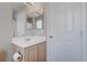 Well-lit bathroom with a vanity, large mirror, and a view of the shower area at 10454 Gunpowder Falls St, Las Vegas, NV 89183