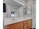Bathroom features double sinks, framed mirror, and decorative transom window for natural light at 10454 Gunpowder Falls St, Las Vegas, NV 89183