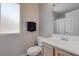 Clean bathroom featuring a toilet, vanity with sink, and a frosted window at 10454 Gunpowder Falls St, Las Vegas, NV 89183
