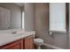 Powder bathroom with a wood cabinet beneath a marble sink, and a privacy window at 10454 Gunpowder Falls St, Las Vegas, NV 89183