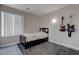 Minimalist bedroom featuring a bed, window and fun guitar accents at 10454 Gunpowder Falls St, Las Vegas, NV 89183