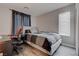Comfortable bedroom featuring a cozy bed, desk, and natural light from a window at 10454 Gunpowder Falls St, Las Vegas, NV 89183