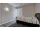 Neat bedroom with simple decor featuring a bed, window, and interesting floor lamp at 10454 Gunpowder Falls St, Las Vegas, NV 89183