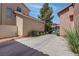 View of the side of the home and driveway lined with tidy landscaping at 10454 Gunpowder Falls St, Las Vegas, NV 89183