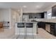 Modern kitchen featuring stainless steel appliances, dark cabinetry, and a breakfast bar with seating at 10454 Gunpowder Falls St, Las Vegas, NV 89183