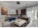 Bright living room features a large sectional sofa, modern decor, and a decorative rug at 10454 Gunpowder Falls St, Las Vegas, NV 89183