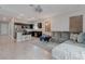 Open-concept living space including a kitchen with a breakfast bar and a living room with a sectional sofa at 10454 Gunpowder Falls St, Las Vegas, NV 89183