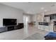 Spacious living room and kitchen area with a dining table and bar seating at 10454 Gunpowder Falls St, Las Vegas, NV 89183