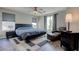 Comfortable main bedroom featuring a king bed, seating area, and lots of natural light at 10454 Gunpowder Falls St, Las Vegas, NV 89183