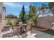 Backyard patio with a dining table, chairs, and tidy landscaping at 10454 Gunpowder Falls St, Las Vegas, NV 89183