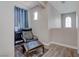Cozy landing area with comfortable chair, side table, and natural light at 10454 Gunpowder Falls St, Las Vegas, NV 89183