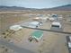 An aerial view shows the home's surroundings, desert landscape and nearby airport properties at 1100 Mitchell Pl, Pahrump, NV 89060