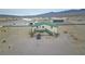 An aerial view shows the home's surroundings, desert landscape and nearby airport properties at 1100 Mitchell Pl, Pahrump, NV 89060