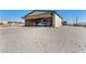 View of Airplane Hangar, concrete floor, with bi-fold door open, airplane inside, and storage shelves at 1100 Mitchell Pl, Pahrump, NV 89060