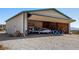 Airplane Hangar with tools, airplane inside, open bi-fold door with bright, open, airy space at 1100 Mitchell Pl, Pahrump, NV 89060