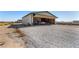View of Airplane Hangar, concrete floor, with bi-fold door open, airplane inside, and storage shelves at 1100 Mitchell Pl, Pahrump, NV 89060