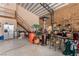 Large hangar with workshop area featuring stairs to the second level, a refrigerator, and open workspace at 1100 Mitchell Pl, Pahrump, NV 89060